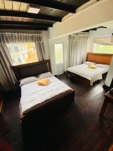 Postel nebo postele na pokoji v ubytování The Loversleap Resort Nuwara Eliya