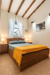 a bedroom with a large bed and a window at 7th - Sea Home in Alexandroupoli