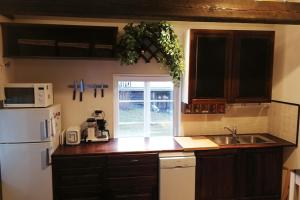 a kitchen with a white refrigerator and a sink at Villa Helena in Naantali
