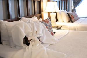 a bedroom with two beds with white sheets and pillows at The Marshall House, Historic Inns of Savannah Collection in Savannah