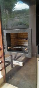 a fireplace in a room with a painting on the wall at Chalé Serrano in Guaramiranga