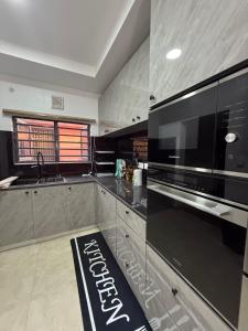 a kitchen with a large black microwave oven in it at Harolds Place in Lagos +13 photos