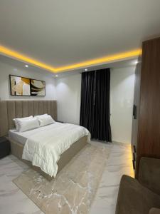 a bedroom with a large bed and a window at Harolds Place in Lagos