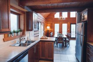 a kitchen with a sink and a dining room at Le Tranquille in Mont-Blanc