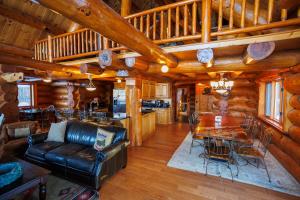 a living room with a couch and a table in a cabin at Log Retreat at Fish Creek by Simple Life Rentals in Fish Creek