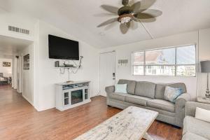 a living room with a couch and a flat screen tv at Oceanfront Galveston Home on Terramar Beach in Galveston