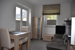 ein Wohnzimmer mit einem Schreibtisch und einem Sofa in der Unterkunft Ferienwohnung an der Obermosel in Oberbillig