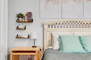 a bedroom with a bed with a wooden table and a desk at Cozy studio in the FAN museums free parking in Richmond