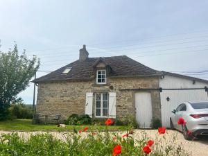 a stone house with a car parked in front of it at Cottage B&B Chateau Saintonge breakfast included in Le Chevain