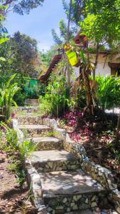 a stone path in front of a house at Bela Oyá Casa Hostel in Vale do Capao