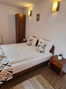 a bedroom with a large bed with pillows on it at Cтаи за гости Бърдареви in Bansko