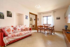 a living room with a couch and a table at Casa Mariposa in Alghero