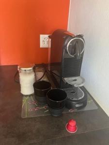 a toaster oven sitting on a shelf with pots at Charmant appart, avec parking à quelques minutes du départ des télécabines in Crans-Montana