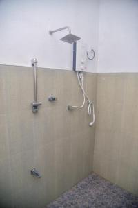 a shower in a bathroom with a shower head at Edward's Bungalow in Tangalle