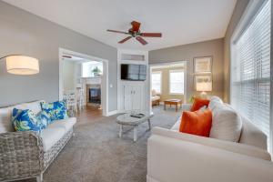 a living room with a white couch and a tv at Spacious Mooresville Home with Lake Norman View! in Mooresville