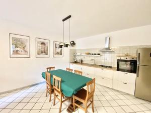 a kitchen with a table and chairs and a refrigerator at Casa Edoardo in Pizzo