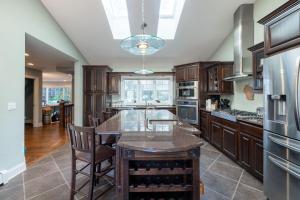 a kitchen with wooden cabinets and a large island at Kings Landing by Simple Life Rentals in Sister Bay +35 photos