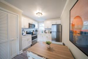 a kitchen with a wooden table and a refrigerator at OV Mosaic - Sienna Suite in North Camellia Acres
