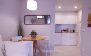 a kitchen and dining room with a table and chairs at Budget Beach Studio 24 in Calonge +16 photos