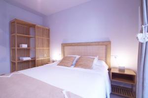 a bedroom with a white bed with two pillows at Budget Beach Studio 24 in Calonge