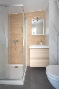 a bathroom with a shower and a toilet and a sink at Apartment Kaptol in Zagreb