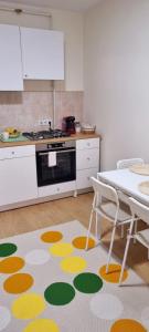 a kitchen with a table and a kitchen rug at Casa in centrul Zalaului in Zalău