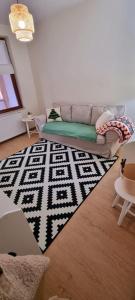 a living room with a couch and a rug at Casa in centrul Zalaului in Zalău