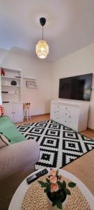 a living room with a couch and a table at Casa in centrul Zalaului in Zalău