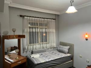 a small bedroom with a bed and a window at Mk Bigg Boss Otel in Erzurum