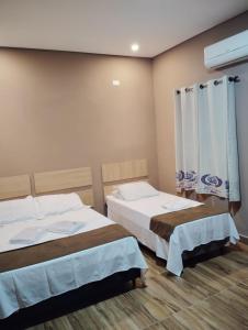 Postel nebo postele na pokoji v ubytování Attriun Hotel