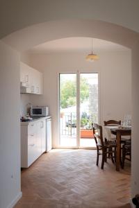 a kitchen and dining room with a table and a kitchen and a window at Merumalia Wine Resort in Frascati