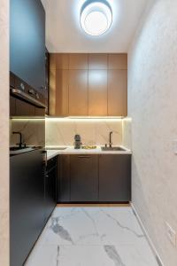 a kitchen with brown cabinets and a sink at Royal Residence Zlatibor in Zlatibor +82 photos