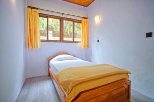 Postel nebo postele na pokoji v ubytování Uns Hotel - Bali