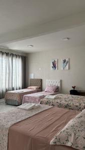 a room with three beds in a room at Apto. Aconchego familiar c/cozinha até 06 pessoas in Rio Branco