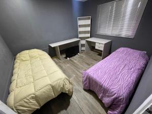 a bedroom with a bed and a desk and a sink at Casa San Rafael (Centro) in San Rafael +2 photos