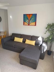 a living room with a couch and a painting on the wall at Motril - Poniente Beach in Motril