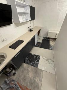 a kitchen with white counters and a sink and a counter at Eksporta apartments 5 in Rīga