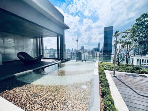 a swimming pool with a chair on a building at AXON Residences Kuala Lumpur in Kuala Lumpur