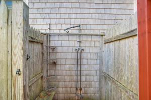 a shower on a brick wall with a wooden fence at Chatham Home with Spacious Deck 2 Mi to Beaches! in Chatham +26 photos