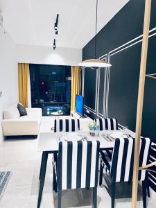a dining room with a table and chairs at AXON Residences Kuala Lumpur in Kuala Lumpur