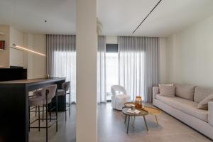 a living room with a couch and a table at Kleopatra Homes - Spiropoulou 11 in Messini