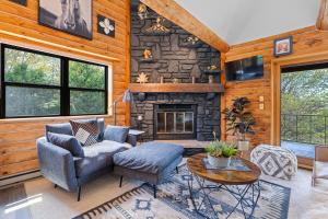 a living room with a stone fireplace in a house at The Great Escape by Simple Life Rentals in Sister Bay