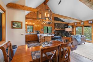 a kitchen and dining room with a wooden table and chairs at The Great Escape by Simple Life Rentals in Sister Bay +42 photos