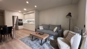 a living room with a couch and a table at BPirineos-Llardana in Benasque
