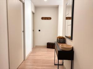 a hallway with a table and a mirror at BPirineos-Llardana in Benasque