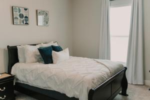 a bedroom with a bed with pillows and a window at Contractor Ready No Penalty Changes Fast Wi-f in Lake Charles