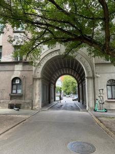 an archway in a building with a person walking through it at Eksporta apartments 5 in Rīga