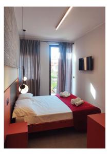a bedroom with a bed with two towels on it at Atto Primo - B&B Experience in Milazzo