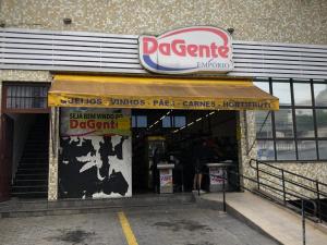a restaurant with a sign on the front of a building at Apartamento Cidade de Deus in Osasco +13 photos