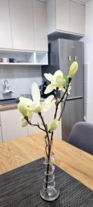 un vaso con fiori su un tavolo in una cucina di CENTRaL FLaT a Sombor